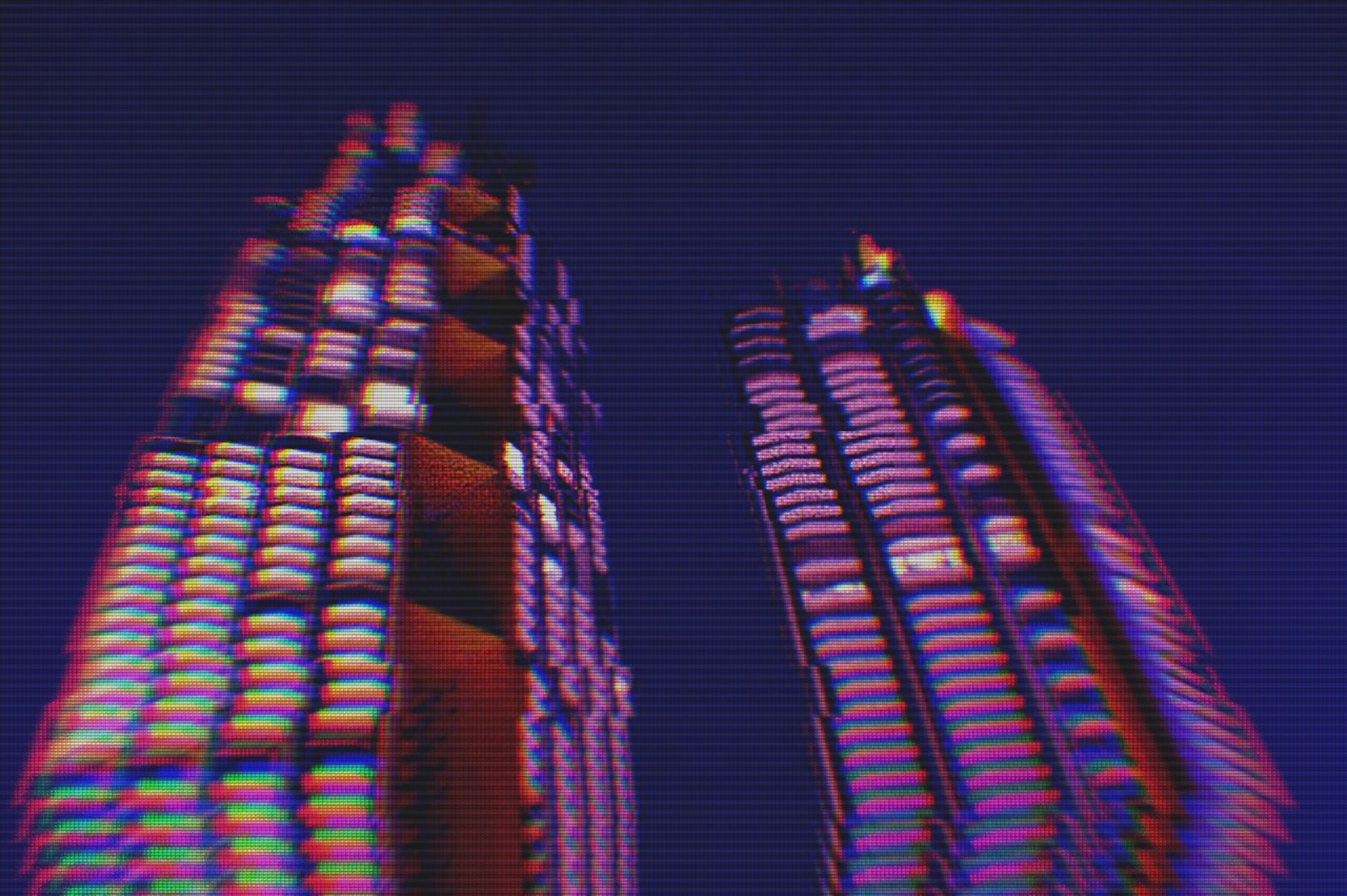 Modern buildings in the city night background with digital glitch effect